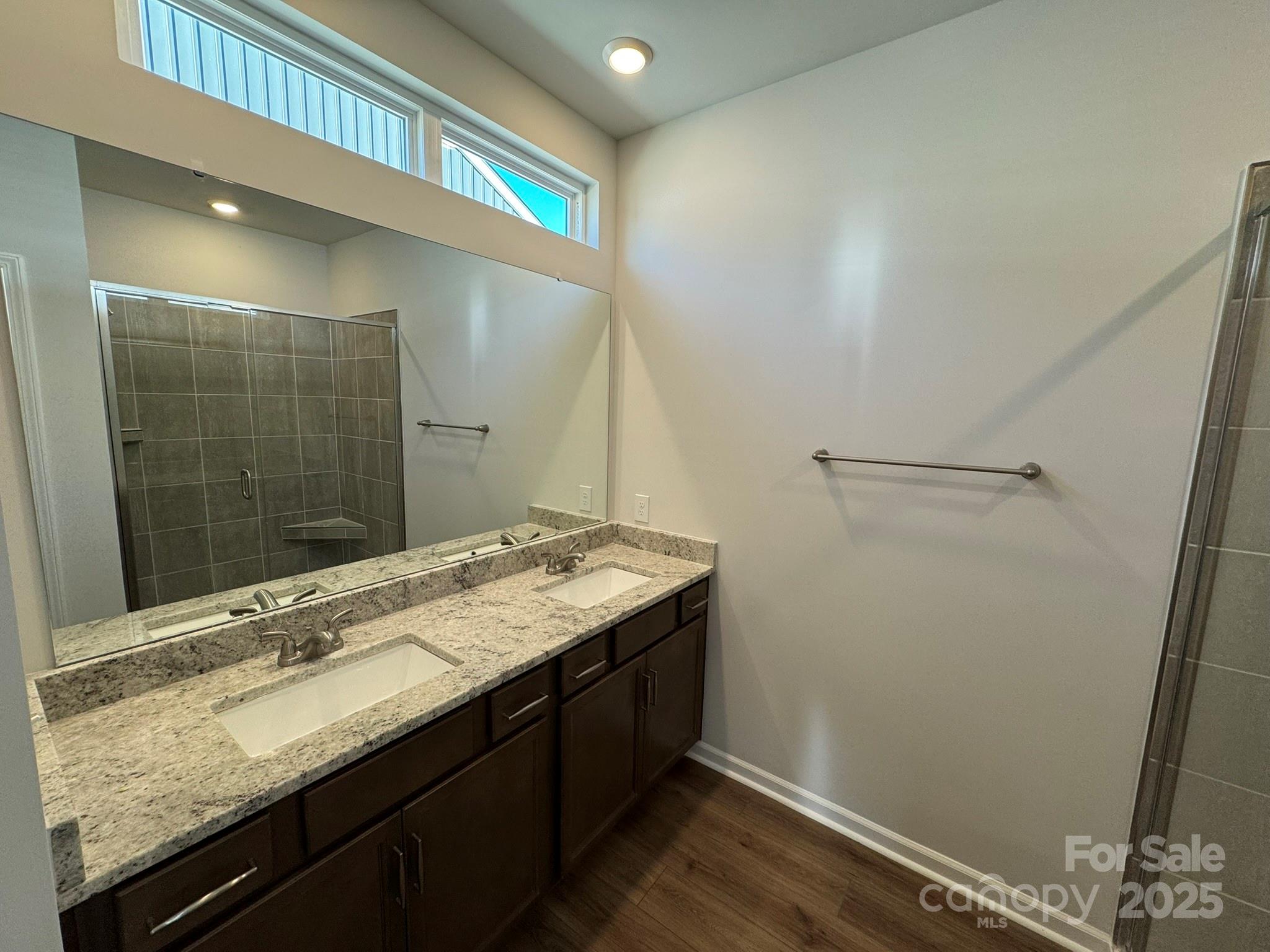 4720 Lakeview Road, Unit 12 Charlotte, NC 28216 - Photo 34 of 41 a bathroom with a granite countertop sink and a mirror