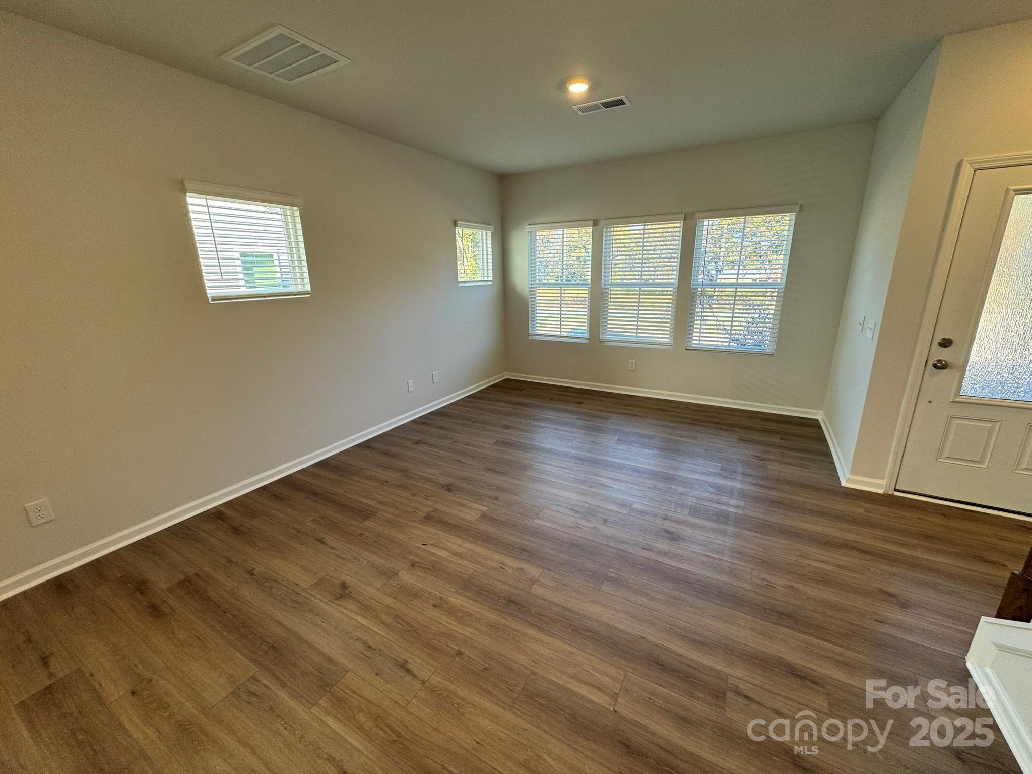 4720 Lakeview Road, Unit 12 Charlotte, NC 28216 - Photo 4 of 41 a view of an empty room with wooden floor and a window