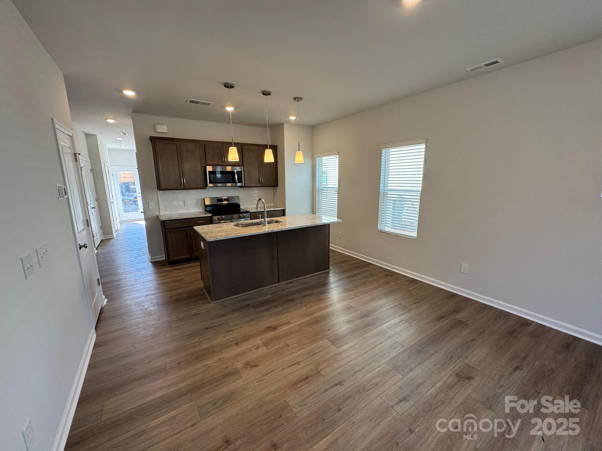 4720 Lakeview Road, Unit 12 Charlotte, NC 28216 - Photo 5 of 41 a view of a kitchen with cabinets stainless steel appliances a sink and a window