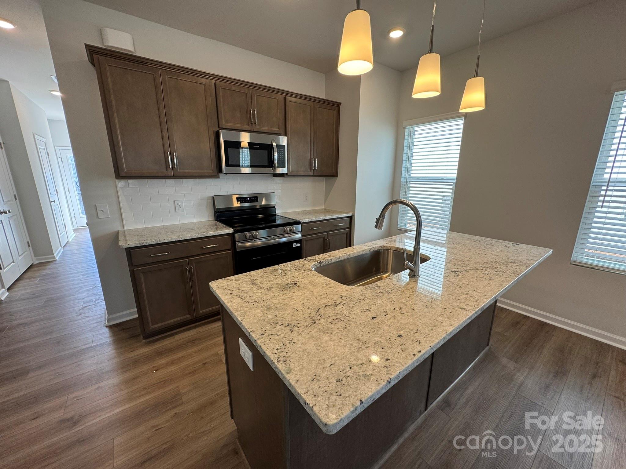 4720 Lakeview Road, Unit 12 Charlotte, NC 28216 - Photo 6 of 41 a kitchen with granite countertop a sink a counter space appliances and cabinets