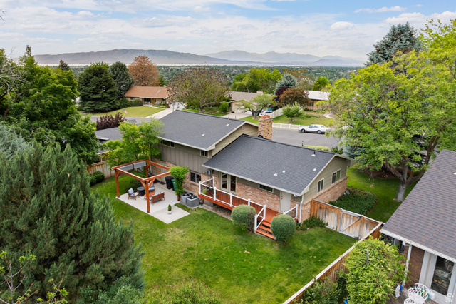 3320 Cherokee Lane Provo, UT 84604 - Photo 49 of 52 Spacious backyard featuring a manicured lawn, a large concrete patio, and a wood pergola