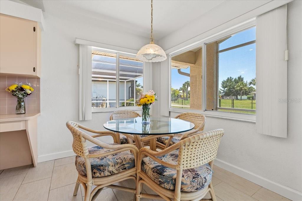 7334 North Tulip Tree Punta Gorda, FL 33955 - Photo 13 of 33 a dining room with furniture a window and chandelier