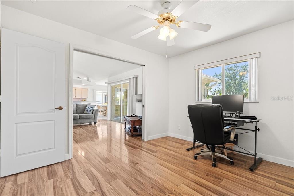 7334 North Tulip Tree Punta Gorda, FL 33955 - Photo 21 of 33 a view of a workspace with wooden floor and a window