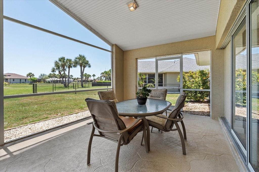 7334 North Tulip Tree Punta Gorda, FL 33955 - Photo 25 of 33 a view of a patio with a table chairs and a backyard