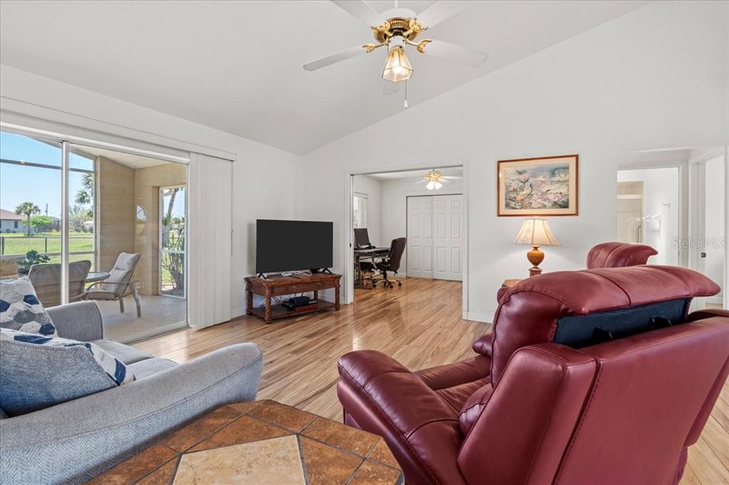 7334 North Tulip Tree Punta Gorda, FL 33955 - Photo 6 of 33 a living room with furniture a large window and a flat screen tv