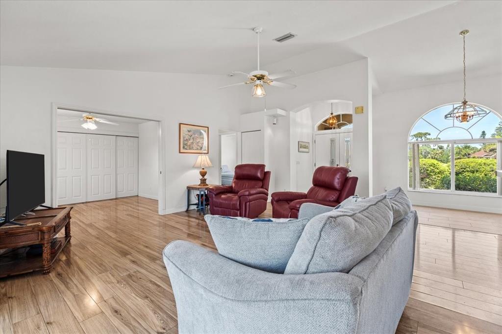 7334 North Tulip Tree Punta Gorda, FL 33955 - Photo 9 of 33 a living room with furniture a chandelier and a flat screen tv