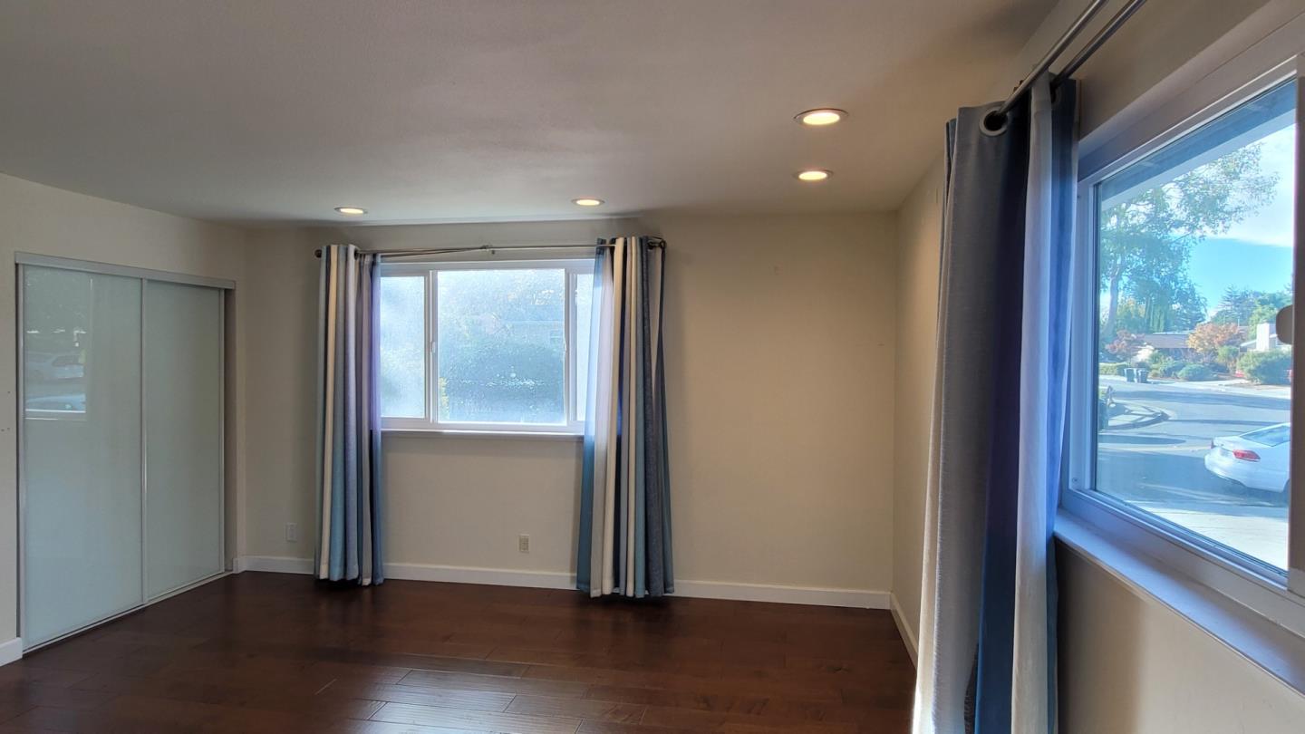 1324 Flicker Way Sunnyvale, CA 94087 - Photo 12 of 16 an empty room with wooden floor and windows