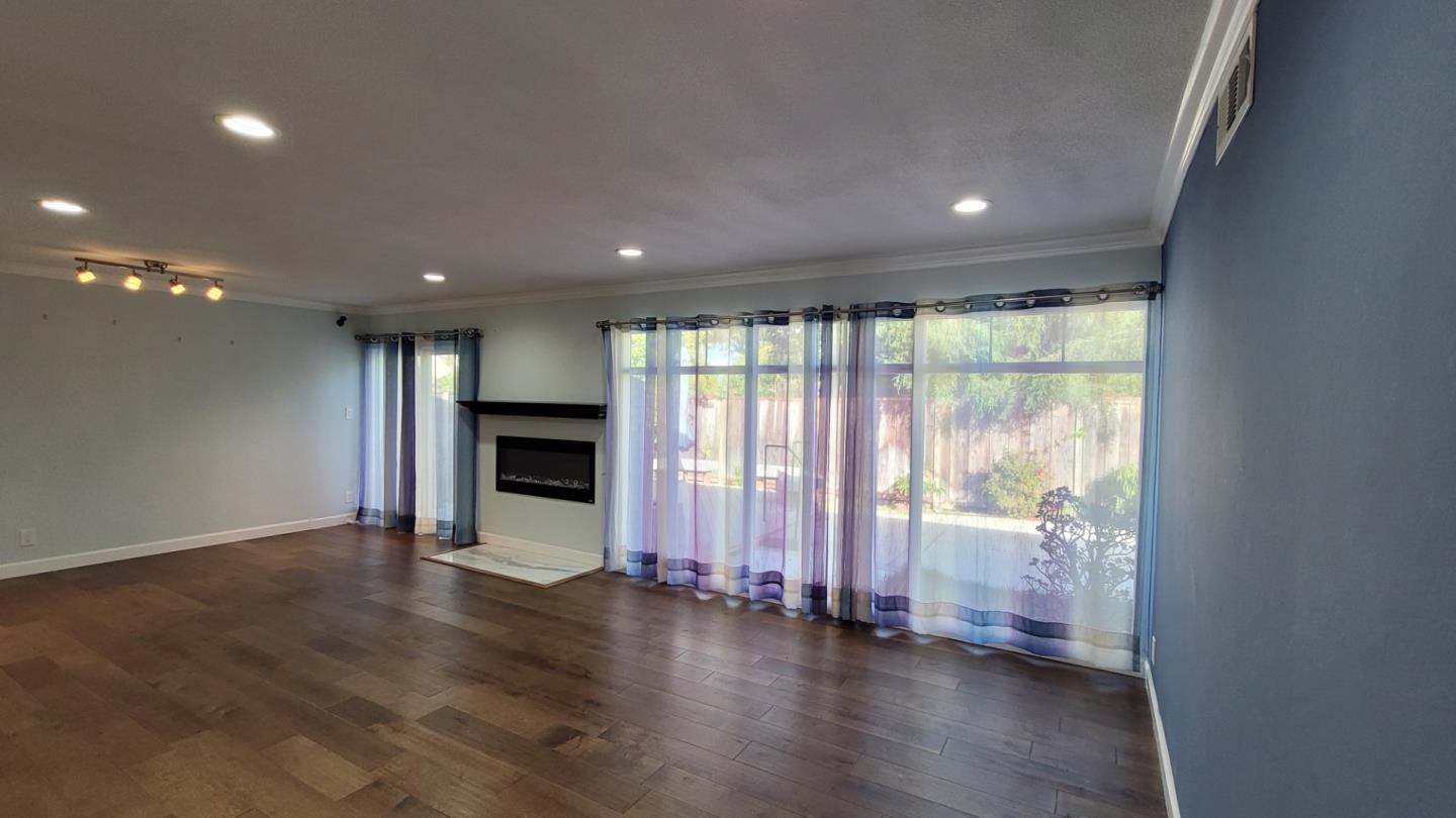 1324 Flicker Way Sunnyvale, CA 94087 - Photo 5 of 16 an empty room with wooden floor and windows