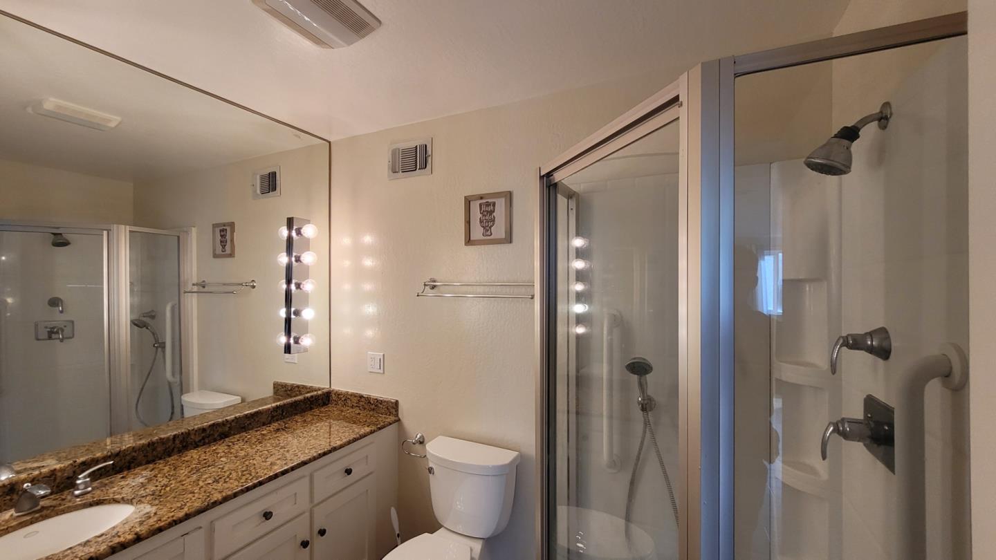 1324 Flicker Way Sunnyvale, CA 94087 - Photo 6 of 16 a bathroom with a granite countertop sink toilet and shower