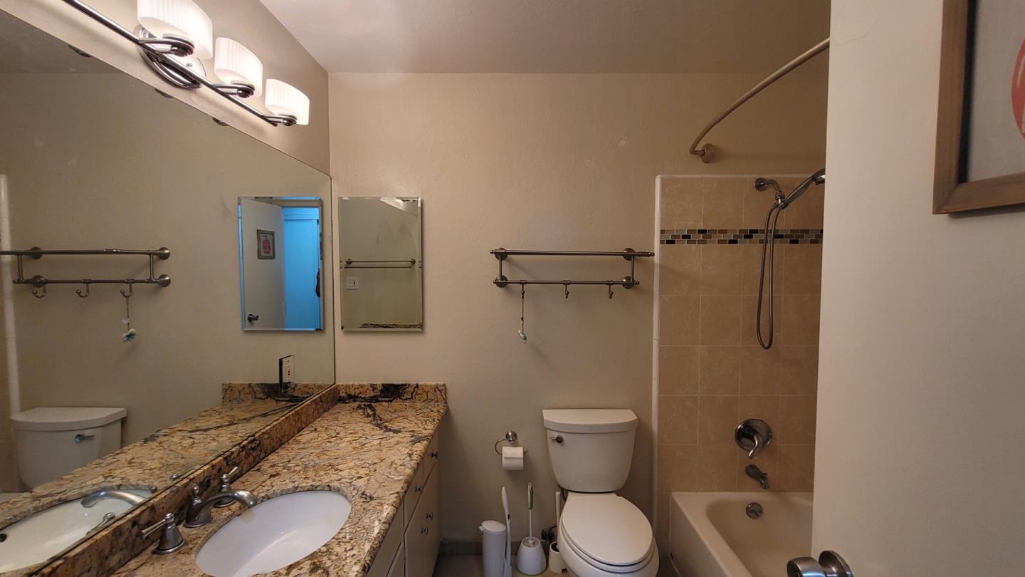 1324 Flicker Way Sunnyvale, CA 94087 - Photo 7 of 16 a bathroom with a granite countertop toilet sink and shower