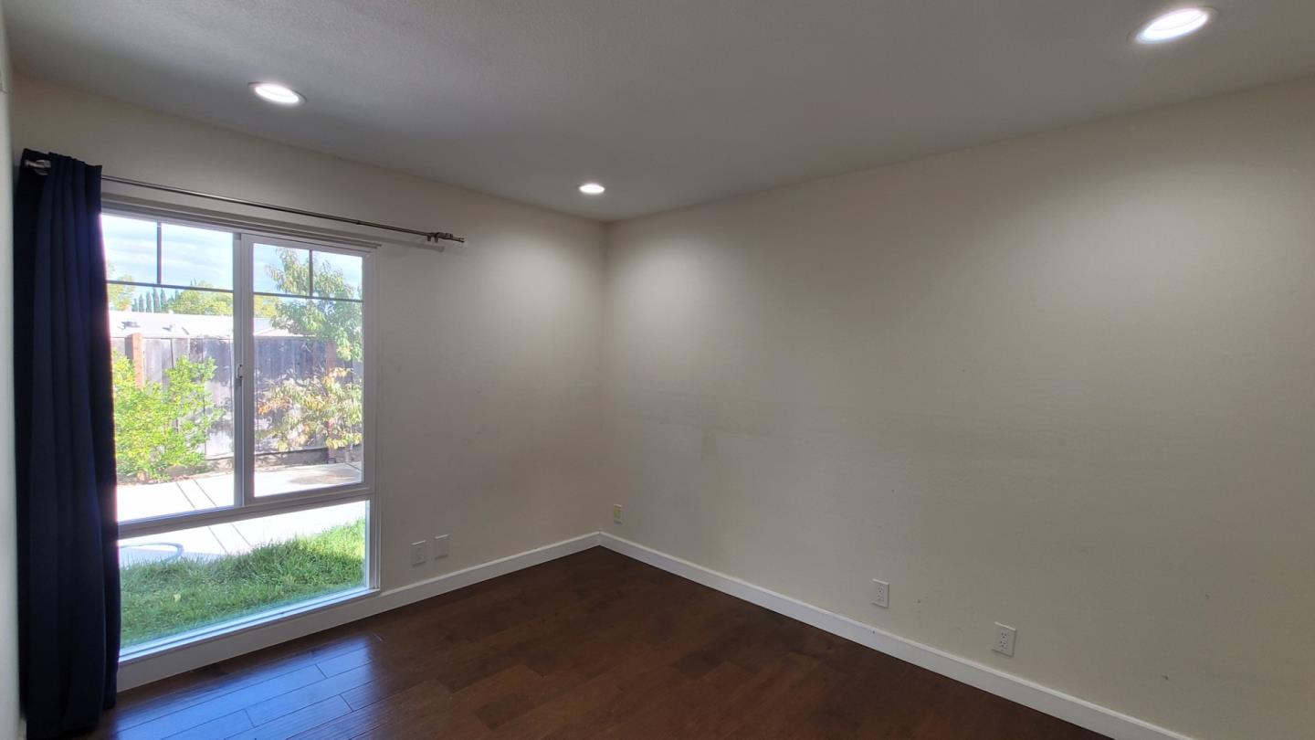 1324 Flicker Way Sunnyvale, CA 94087 - Photo 8 of 16 an empty room with wooden floor and windows