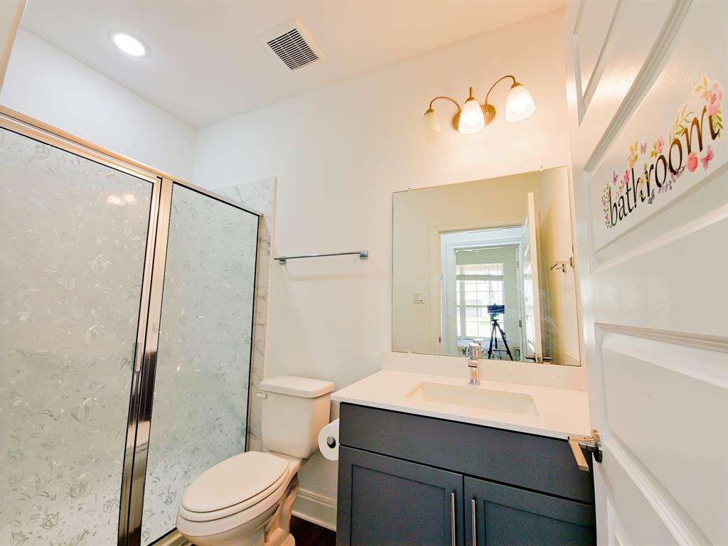 332 Turnbuckle Bend Leander, TX 78641 - Photo 17 of 34 Shower with sliding glass doors and white tiled surround