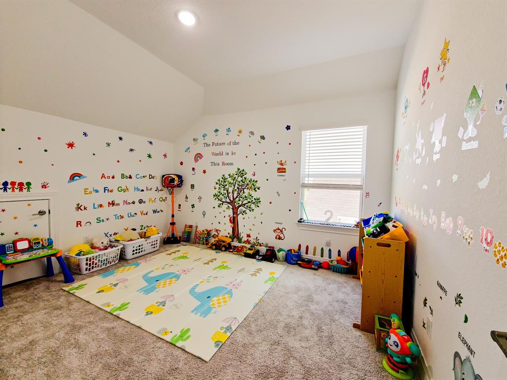 332 Turnbuckle Bend Leander, TX 78641 - Photo 28 of 34 Carpeted room featuring a single window with blinds, a vaulted ceiling, and a recessed ceiling light