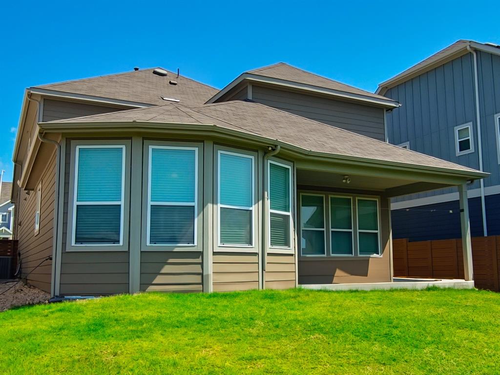 332 Turnbuckle Bend Leander, TX 78641 - Photo 32 of 34 Rear exterior with a covered patio, multiple windows, and a shingled roof