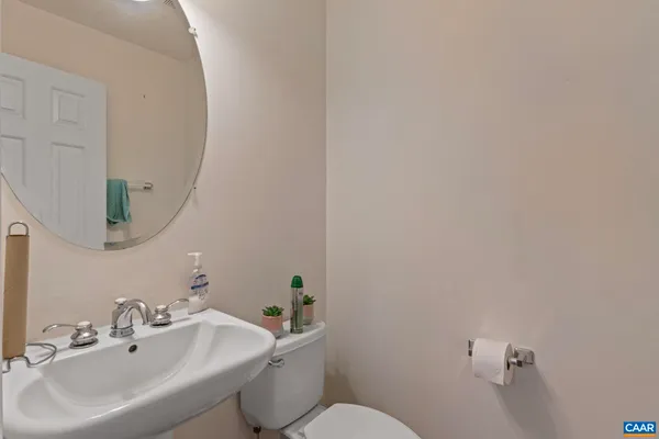 a bathroom with a sink mirror and toilet