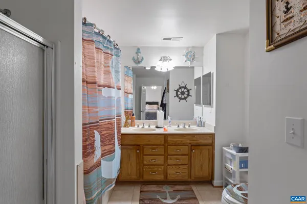 a bathroom with a sink vanity and a mirror