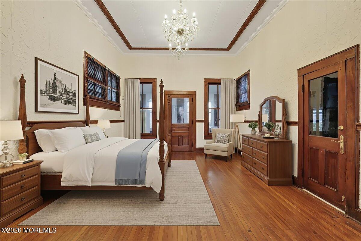 Front Street Keyport, NJ 07735 - Photo 19 of 42 a bedroom with a large bed and a chandelier