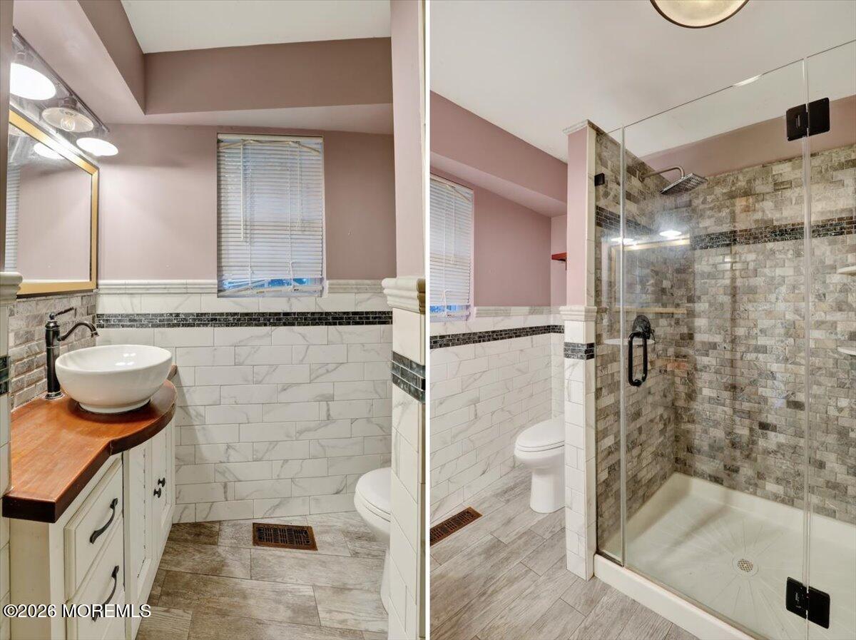 Front Street Keyport, NJ 07735 - Photo 31 of 42 a bathroom with a granite countertop sink a toilet and shower