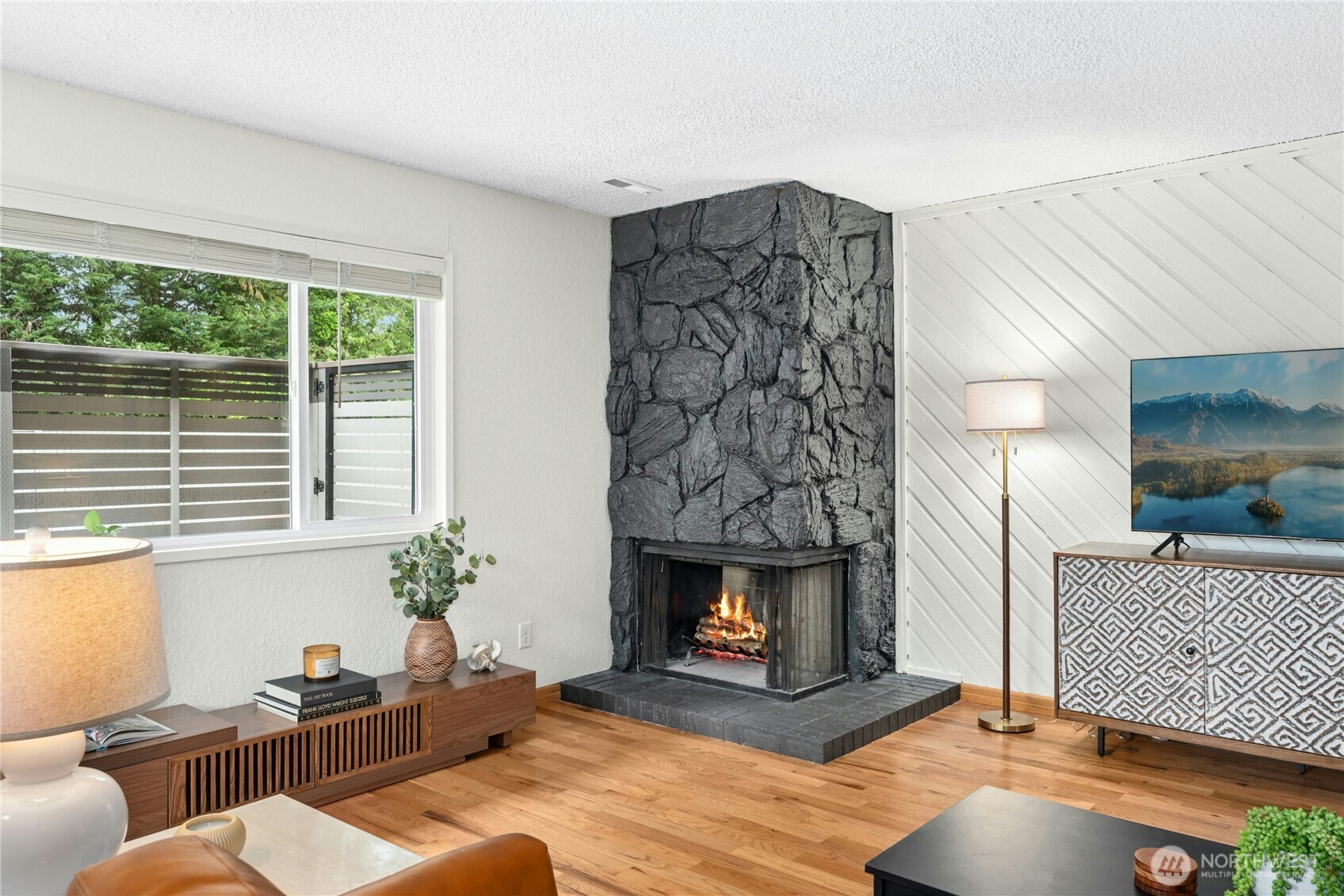 9523 Northeast 180th Street, Unit A102 Bothell, WA 98011 - Photo 5 of 29 a living room with furniture and a fireplace