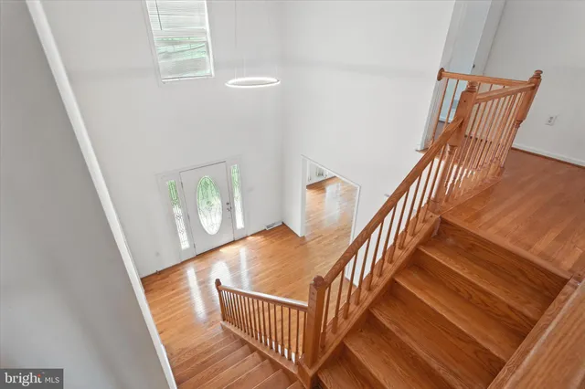 a view of staircase with railing and white walls