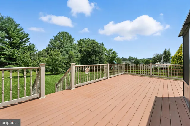 a view of balcony with wooden floor and fence