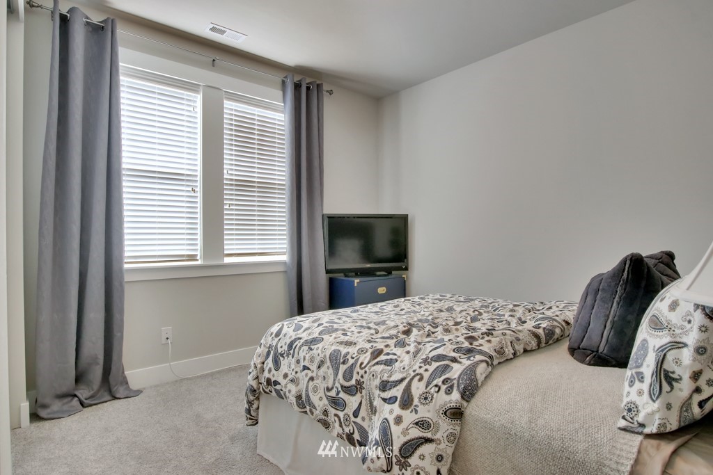 317 Field Place Southeast Renton, WA 98059 - Photo 4 of 29 a bedroom with a bed and a flat screen tv