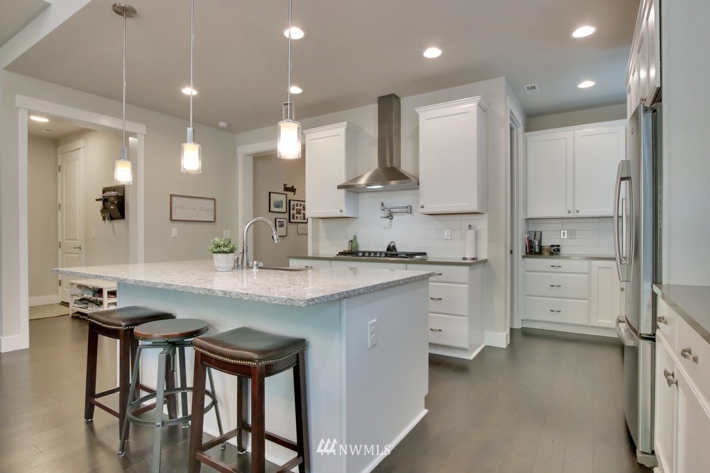 317 Field Place Southeast Renton, WA 98059 - Photo 8 of 29 a kitchen with white cabinets and stainless steel appliances