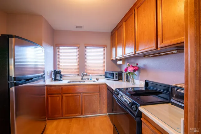 a kitchen that has a sink and a stove