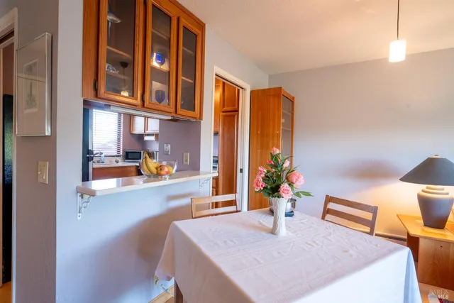 a dining room with a table and chairs