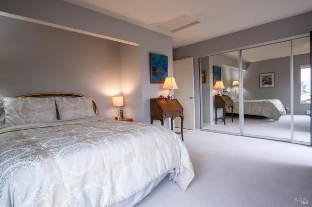 a bedroom with a bed and lamp