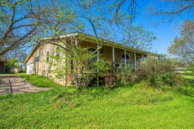 a backyard of a house with lots of green space