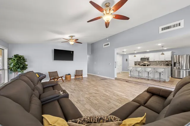a living room with furniture and a chandelier