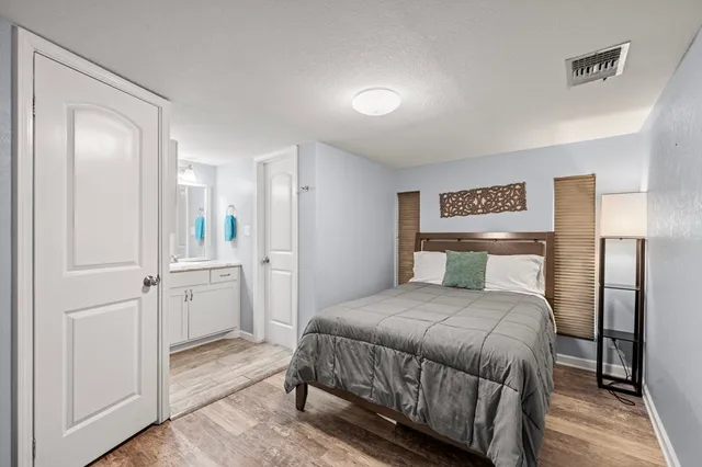 a bedroom with a bed and a table