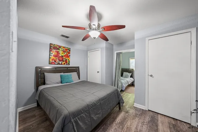 a bedroom with a bed and a chandelier