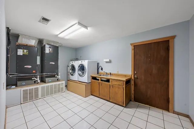 a kitchen with granite countertop a refrigerator and white cabinets