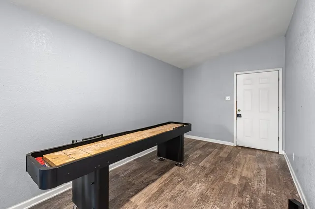 a view of an empty room and wooden floor