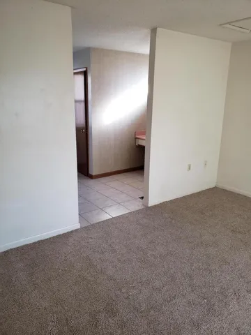 an empty room with closet and mirror