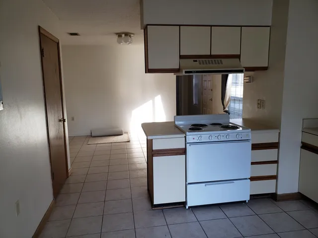 a kitchen with a stove and a refrigerator