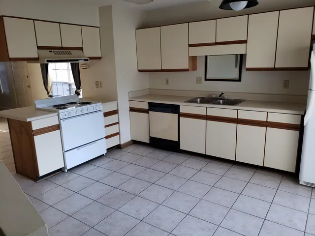 a kitchen with stainless steel appliances granite countertop a sink and a stove