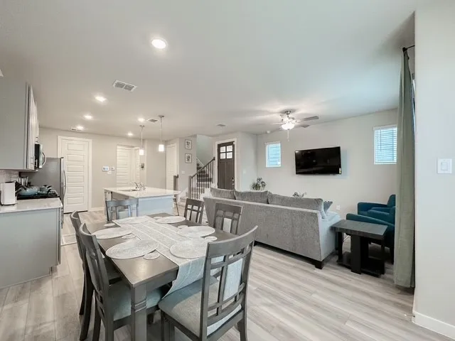 a view of a dining room with furniture and wooden floor