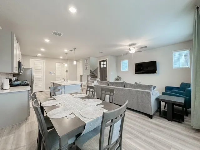 a view of a dining room with furniture and wooden floor