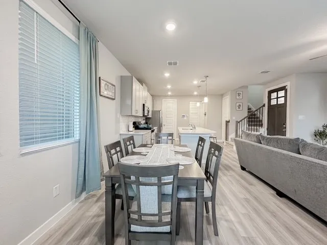 a view of a dining room with furniture and wooden floor