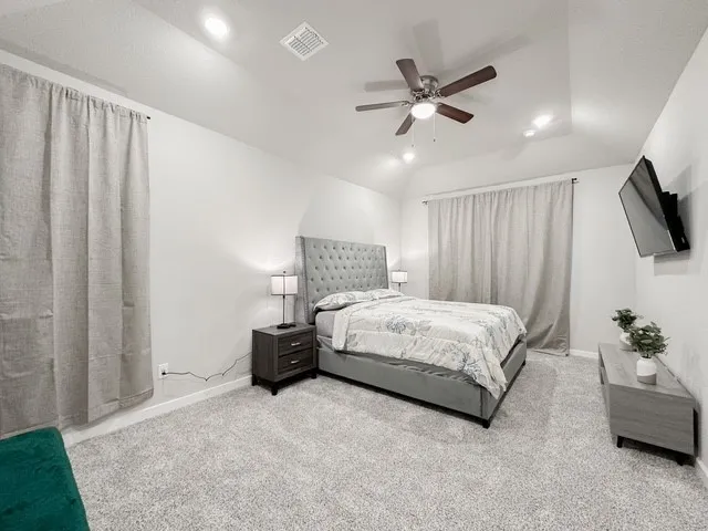 a bedroom with a bed couch and window