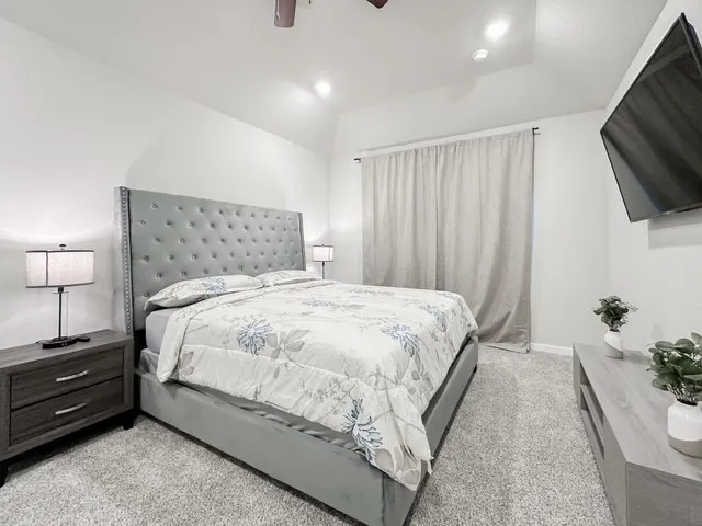 a large bed sitting in a bedroom and tv