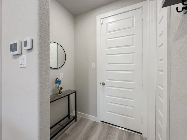 a room that has a bench and a window with wooden floor