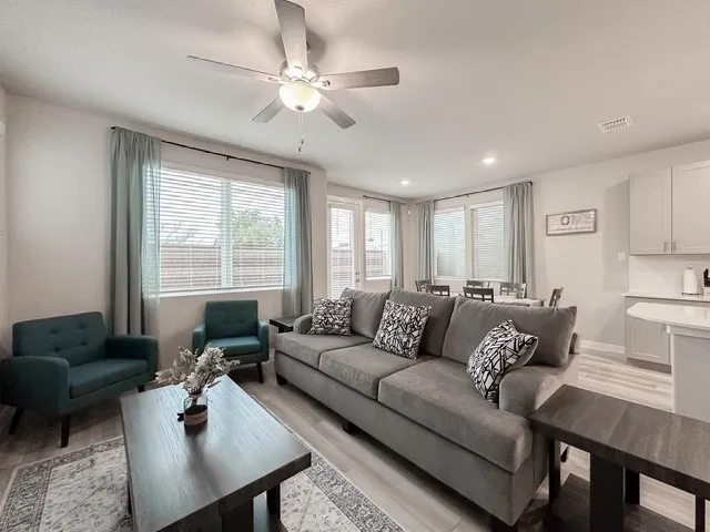 a living room with furniture and a large window
