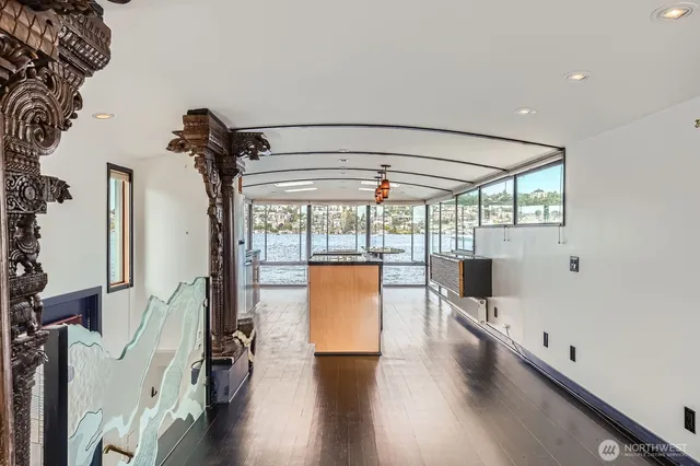 a view of a livingroom with wooden floor and windows