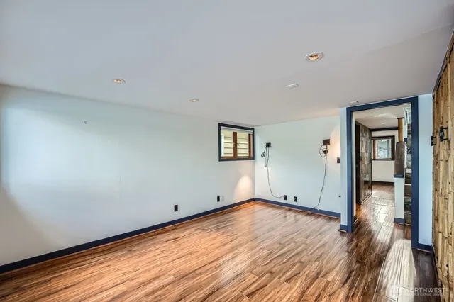 a view of empty room with wooden floor