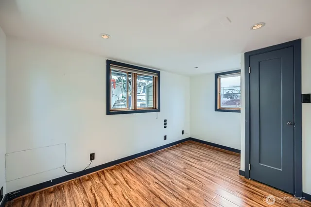 a view of a balcony with wooden floor and outdoor seating
