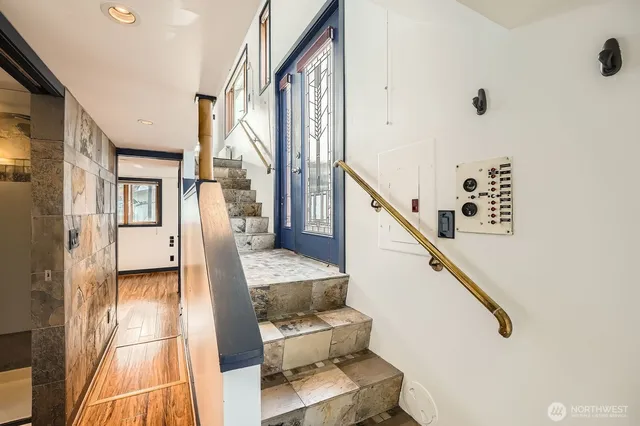 a kitchen with stainless steel appliances granite countertop a stove and a view of living room